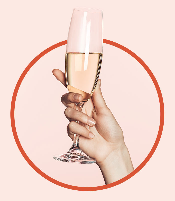 Image of a hand holding a glass of champagne for brunch