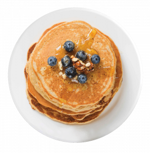 Plate of pancakes with nuts and blueberries