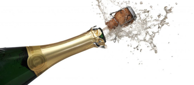 Extreme close-up of explosion of champagne bottle cork